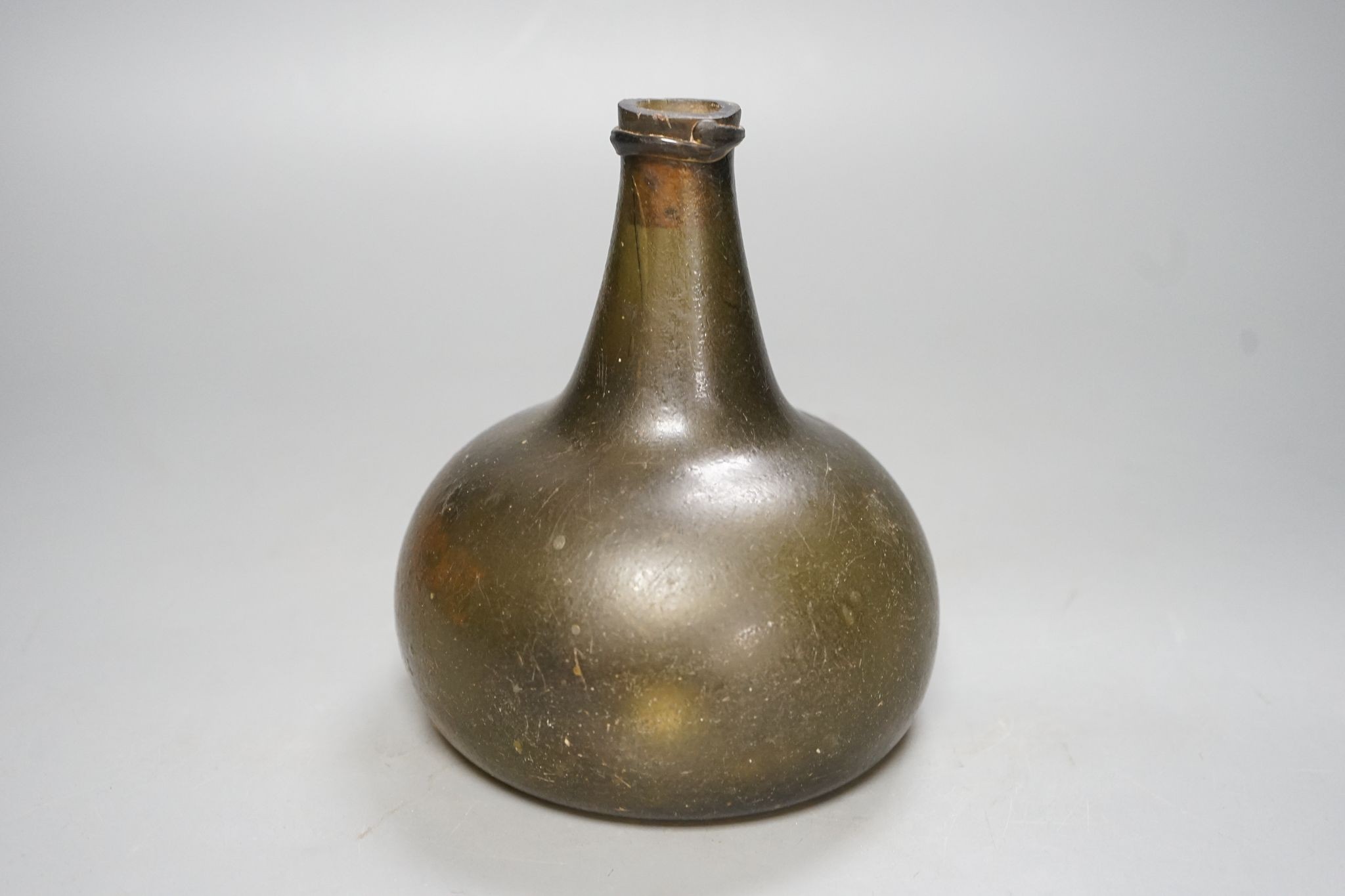 Early 18th century glass onion shaped bottle, 16cm
